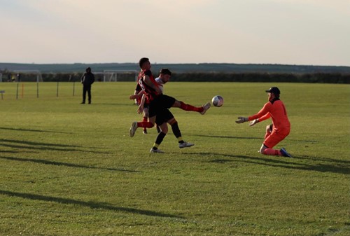 Daryl Mansbridge getting to the ball first to nip it past the keeper to score