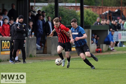 Will Howarth running down the wing challenged by Jake Merry