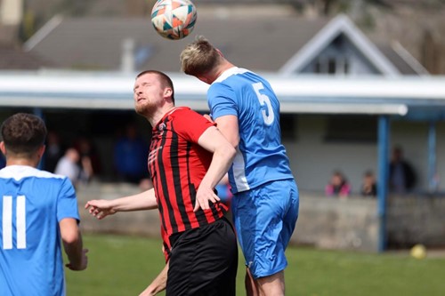 Scott Delaney in one of many aerial duels with Ross Jones throughout the match